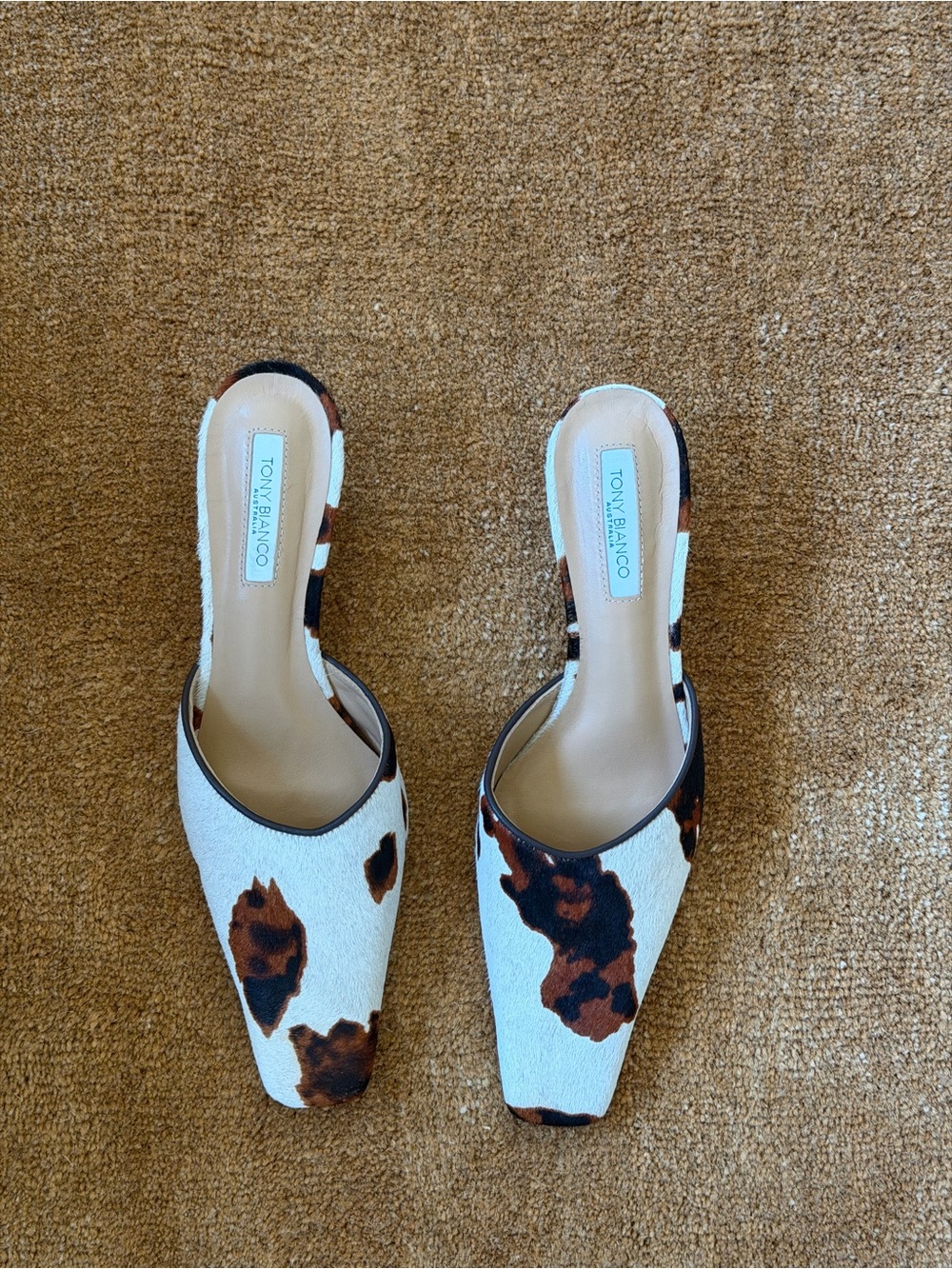 Tony Bianco White Cow-Print Slip-On Mules with Brown Spots